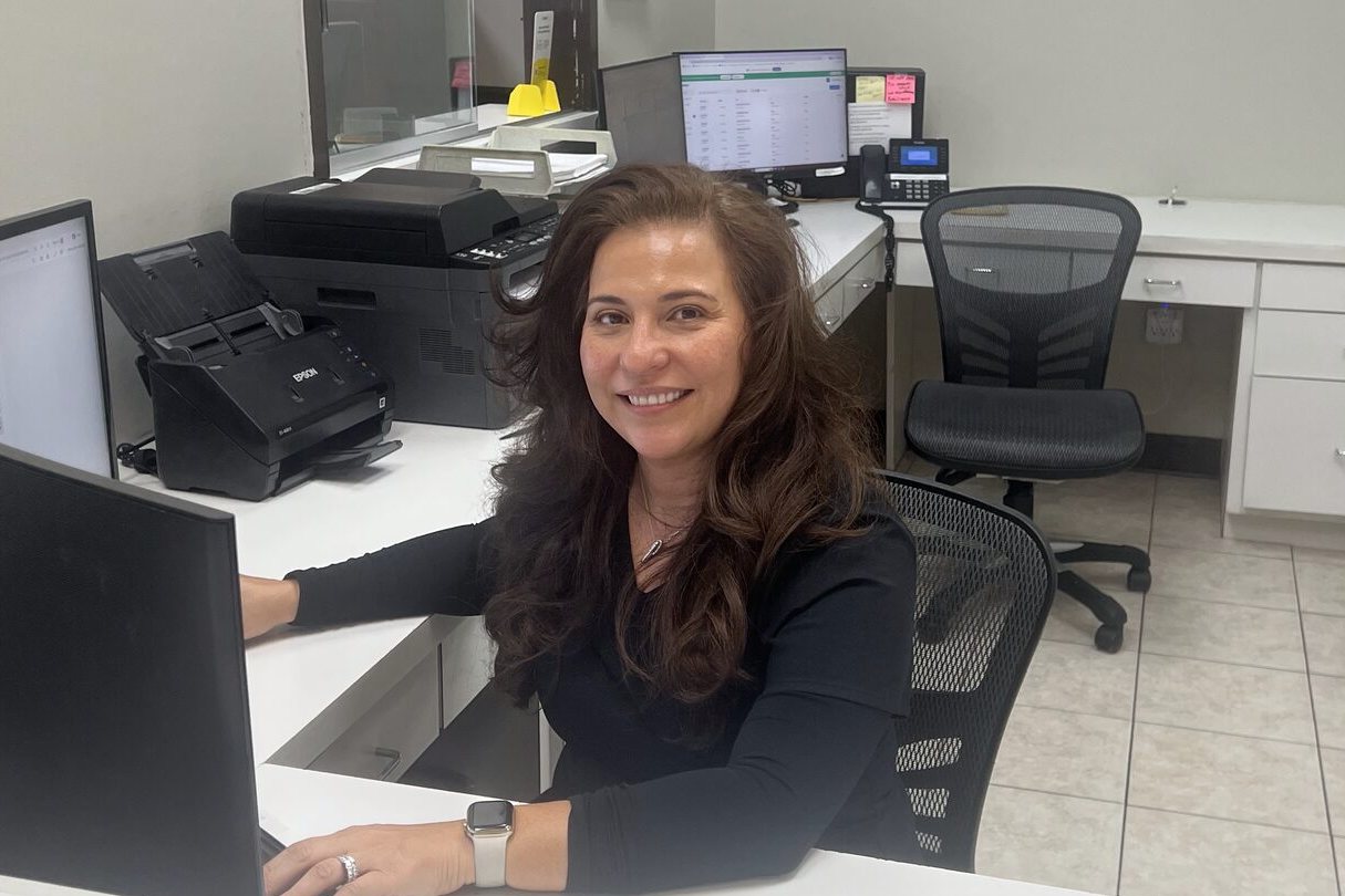 Erica, office manager at J. Griffiths Dentistry, at the front desk
